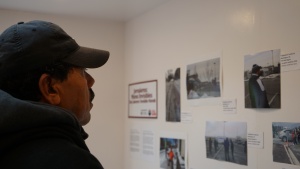A man looks at a photo exhibit
