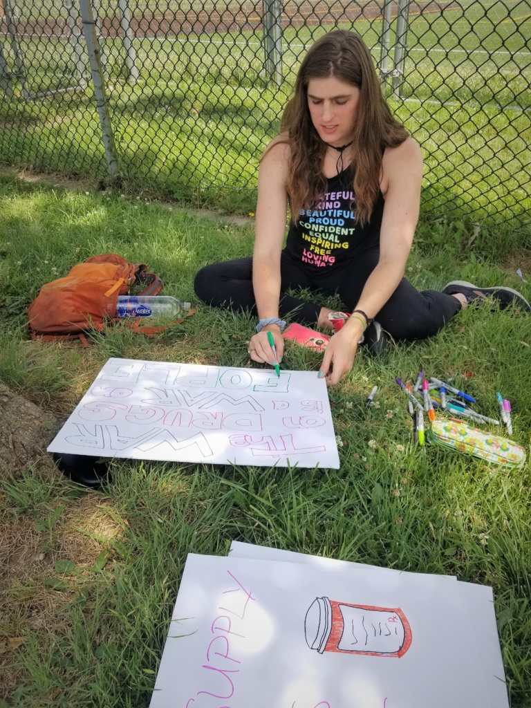 Lia making posters before the "Support, Don't Punish" march. 2021. Photo by Laura Sislen.